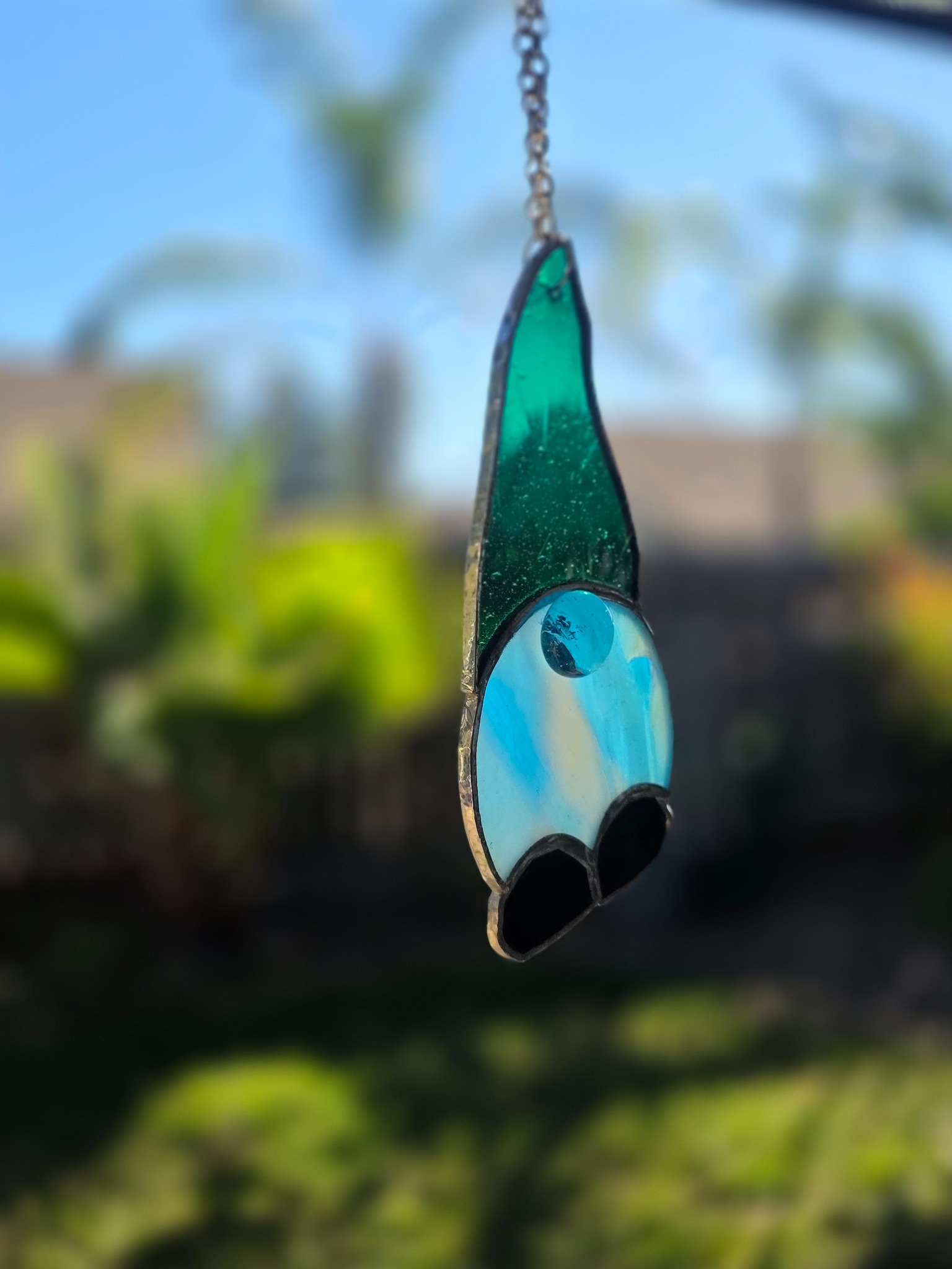 Angled view of the green and blue stained-glass gnome