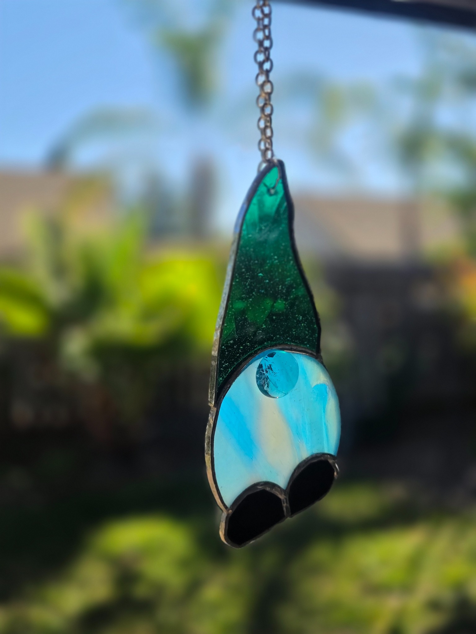 Second angled view of the green and blue stained-glass gnome